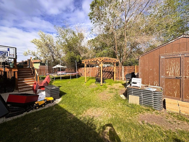 3 30th St, Minot, ND 58701 - fenced backyard with a trampoline, a storage unit, and stairs