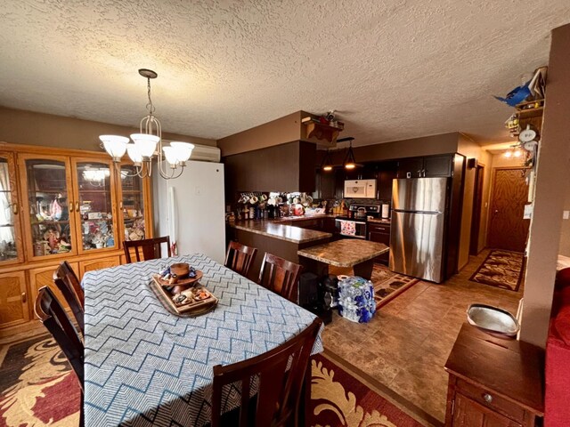 3 30th St, Minot, ND 58701 - dining space featuring a chandelier and a textured ceiling