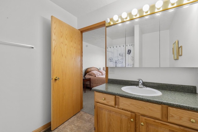 2009 14th St, Minot, ND 58703 - full bathroom featuring vanity and tile patterned floors