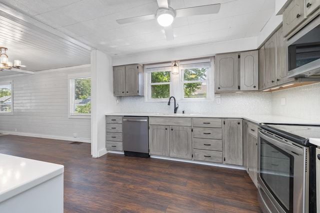 211 W 3rd St, Velva, ND 58790 - kitchen with appliances with stainless steel finishes, gray cabinets, healthy amount of natural light, and dark wood-type flooring
