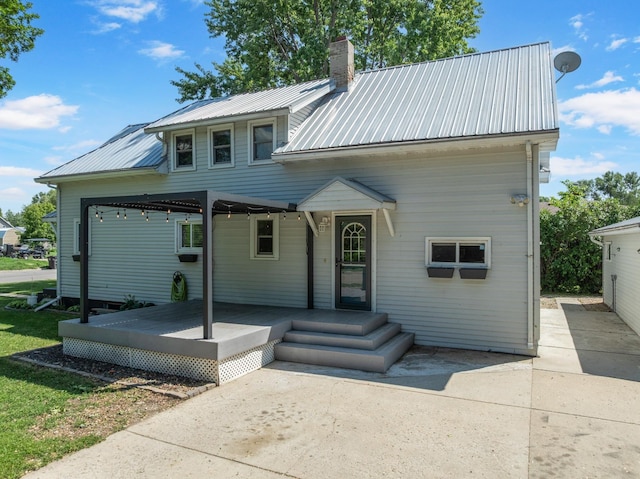211 W 3rd St, Velva, ND 58790 - view of front of property with a chimney and a metal roof