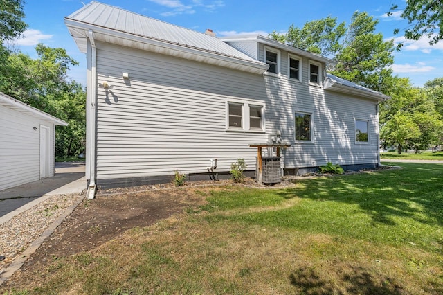 211 W 3rd St, Velva, ND 58790 - rear view of property with a lawn and a metal roof