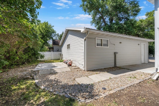 211 W 3rd St, Velva, ND 58790 - view of side of home featuring a patio area