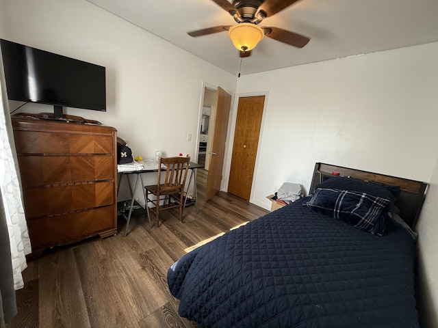 3301 SE 1st St, Minot, ND 58701 - bedroom with dark wood-style flooring, ceiling fan, and a desk
