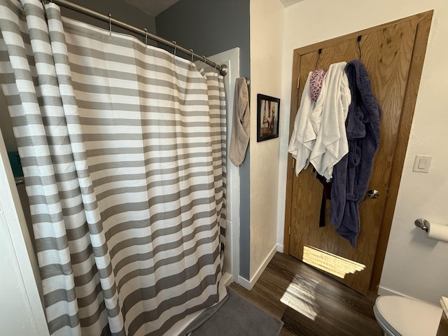 3301 SE 1st St, Minot, ND 58701 - bathroom with wood finished floors and curtained shower
