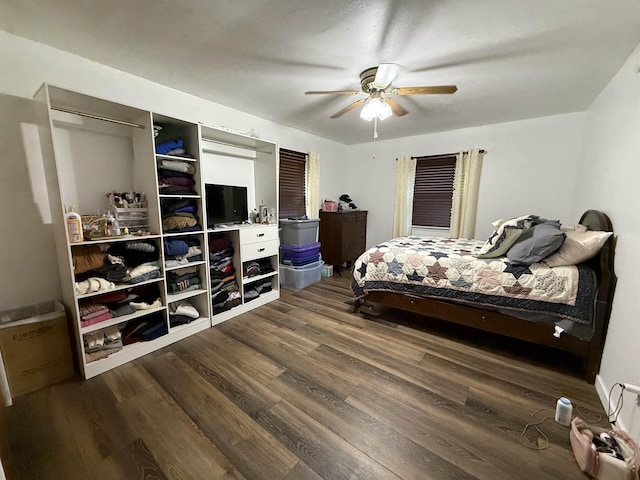 3301 SE 1st St, Minot, ND 58701 - bedroom with dark wood-style flooring and a ceiling fan