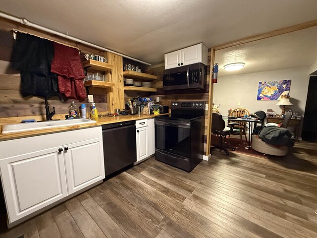 3301 SE 1st St, Minot, ND 58701 - kitchen with dishwasher, black range with electric stovetop, stainless steel microwave, white cabinetry, and open shelves
