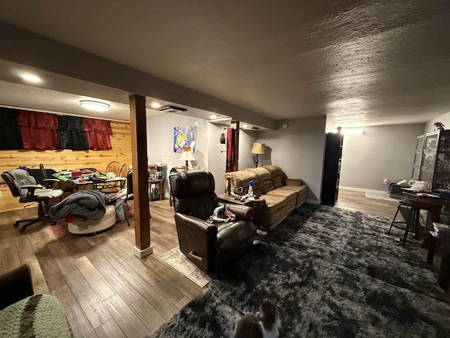 3301 SE 1st St, Minot, ND 58701 - living room with wood finished floors, wood walls, and a textured ceiling