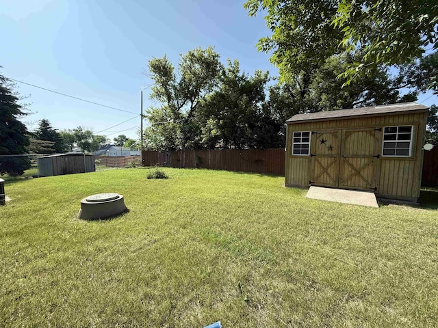 3301 SE 1st St, Minot, ND 58701 - fenced backyard featuring a storage shed and a fire pit