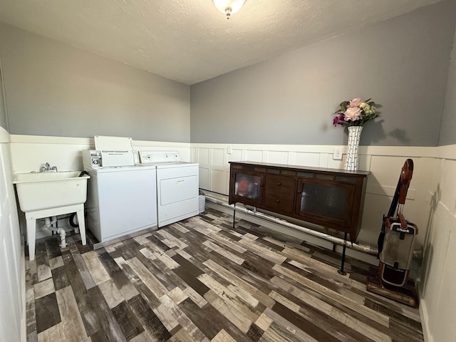 3301 SE 1st St, Minot, ND 58701 - laundry room with independent washer and dryer, wood finished floors, a wainscoted wall, a textured ceiling, and cabinet space