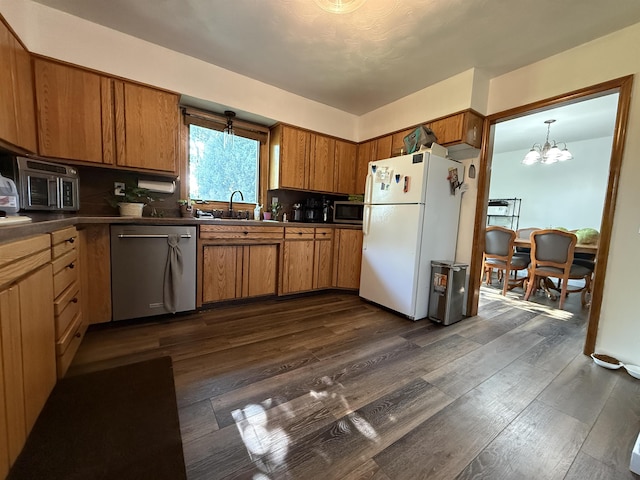 3301 SE 1st St, Minot, ND 58701 - kitchen with appliances with stainless steel finishes, dark countertops, and brown cabinets