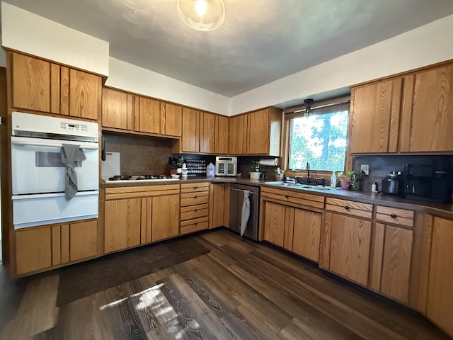 3301 SE 1st St, Minot, ND 58701 - kitchen with white appliances, a warming drawer, dark wood finished floors, and dark countertops