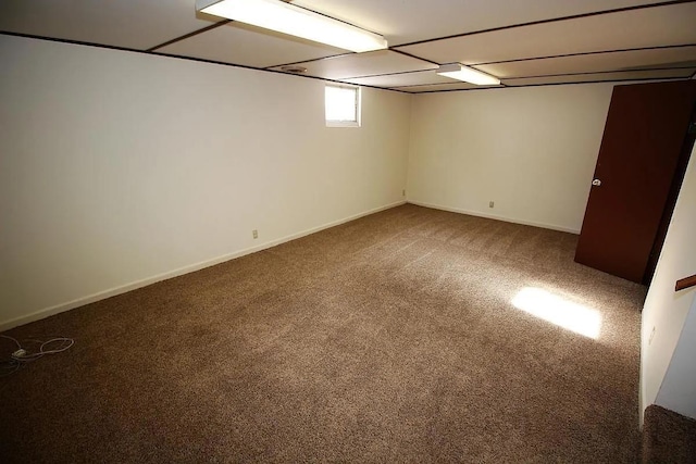1809 Main St, Minot, ND 58701 - below grade area featuring carpet and baseboards