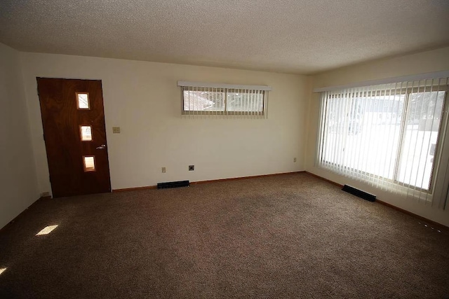 1809 Main St, Minot, ND 58701 - empty room featuring a textured ceiling and carpet floors