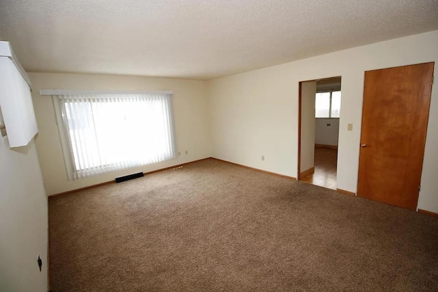 1809 Main St, Minot, ND 58701 - empty room featuring healthy amount of natural light and carpet flooring