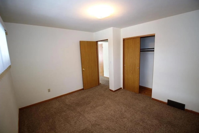 1809 Main St, Minot, ND 58701 - unfurnished bedroom featuring carpet flooring and a closet