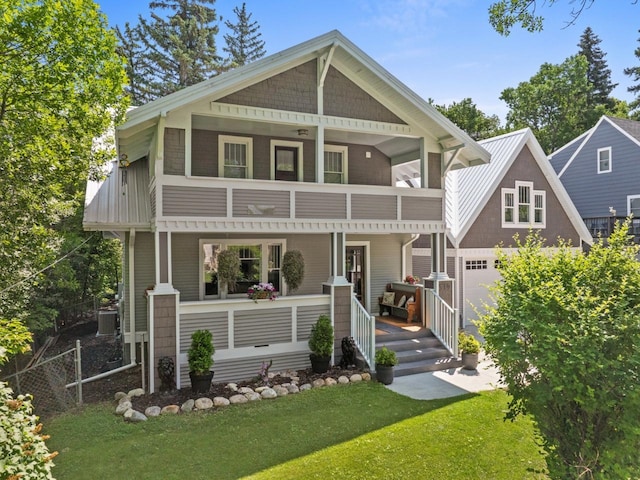 519 4th St, Minot, ND 58701 - view of front of home featuring a porch, a front yard, and a balcony