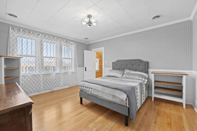 519 4th St, Minot, ND 58701 - bedroom featuring light wood-style flooring and crown molding