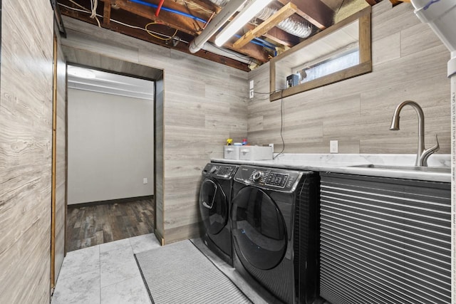 519 4th St, Minot, ND 58701 - washroom with washing machine and clothes dryer and wood walls