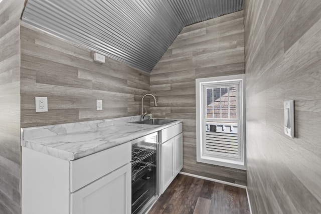 519 4th St, Minot, ND 58701 - kitchen with wine cooler, lofted ceiling, white cabinets, dark wood finished floors, and wooden ceiling