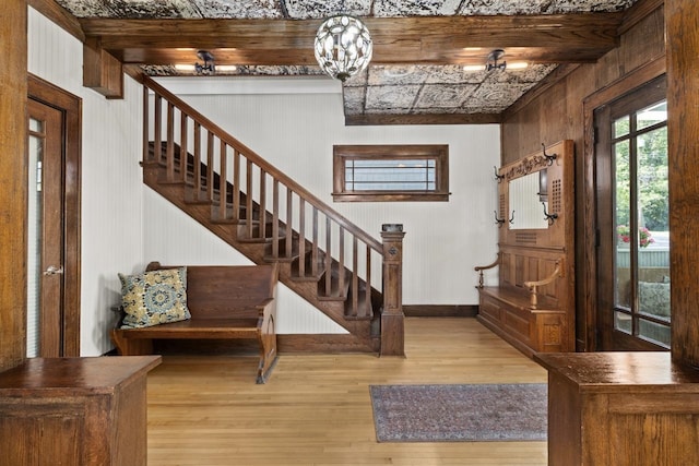 519 4th St, Minot, ND 58701 - entryway with wood finished floors, stairs, and wood walls