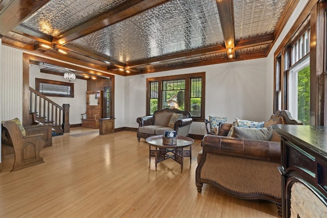 519 4th St, Minot, ND 58701 - living room featuring light wood-style flooring, stairs, an ornate ceiling, coffered ceiling, and beamed ceiling