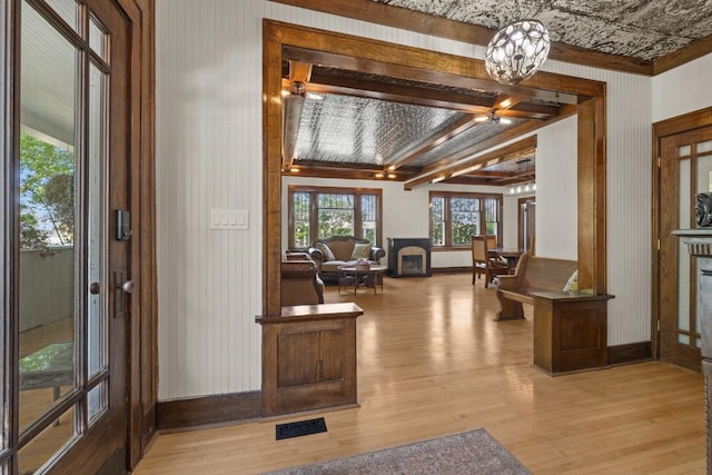 519 4th St, Minot, ND 58701 - entrance foyer with light wood finished floors and a chandelier