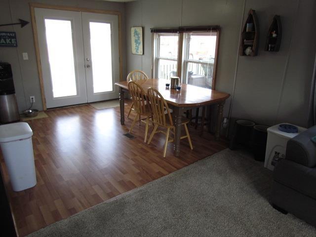 83 Hahns Bay Rd, Lake Metigoshe, ND 58318 - dining space with french doors and wood finished floors
