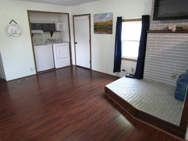 83 Hahns Bay Rd, Lake Metigoshe, ND 58318 - living area with wood finished floors and washing machine and clothes dryer