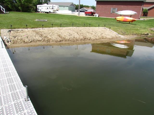 83 Hahns Bay Rd, Lake Metigoshe, ND 58318 - dock area featuring a lawn and a water view