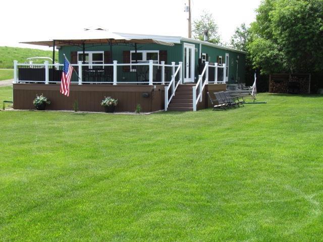83 Hahns Bay Rd, Lake Metigoshe, ND 58318 - back of house with a yard and a deck
