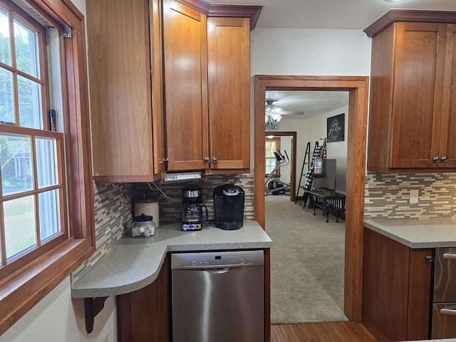209 University Ave, Minot, ND 58703 - kitchen featuring dishwasher, decorative backsplash, and brown cabinets