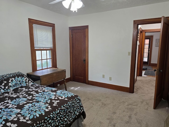 209 University Ave, Minot, ND 58703 - carpeted bedroom with baseboards and a ceiling fan