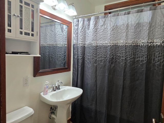 209 University Ave, Minot, ND 58703 - full bathroom with toilet and a shower with shower curtain