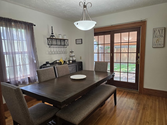 209 University Ave, Minot, ND 58703 - dining area featuring wood finished floors and a textured ceiling