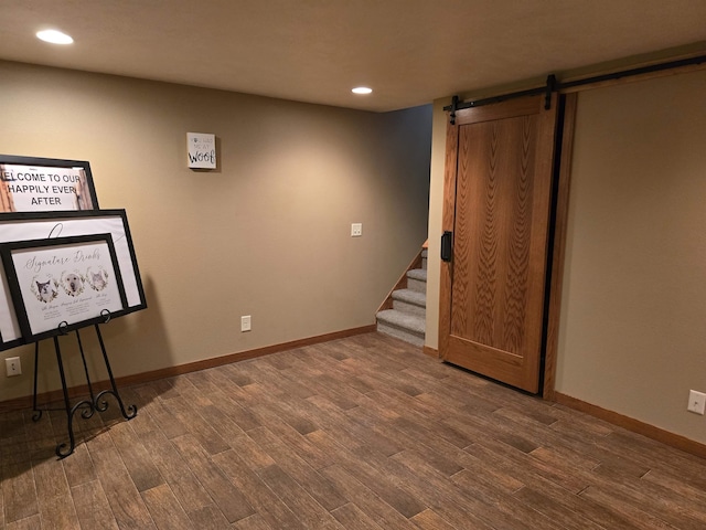 209 University Ave, Minot, ND 58703 - finished below grade area featuring a barn door, wood finished floors, recessed lighting, and stairway