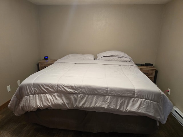 209 University Ave, Minot, ND 58703 - bedroom with wood finished floors and baseboard heating