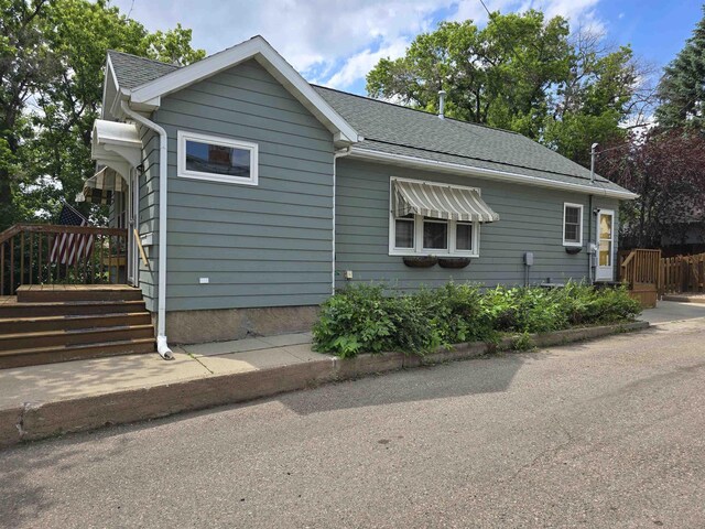209 University Ave, Minot, ND 58703 - view of front facade featuring a shingled roof