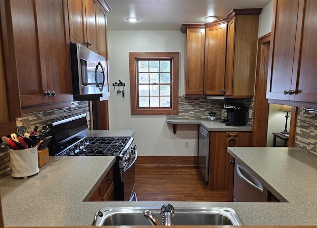 209 University Ave, Minot, ND 58703 - kitchen featuring stainless steel appliances, decorative backsplash, and brown cabinetry
