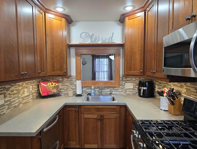 209 University Ave, Minot, ND 58703 - kitchen featuring appliances with stainless steel finishes, decorative backsplash, and brown cabinets
