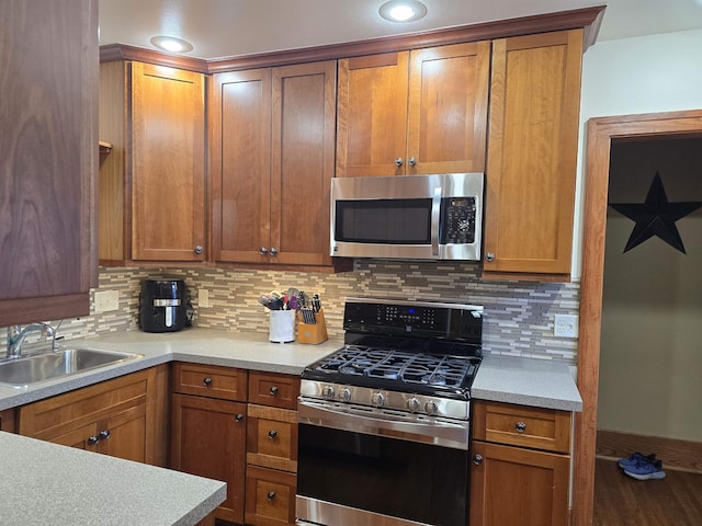 209 University Ave, Minot, ND 58703 - kitchen featuring stainless steel appliances, backsplash, and light countertops