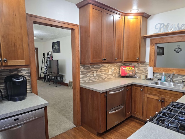 209 University Ave, Minot, ND 58703 - kitchen with dishwasher, tasteful backsplash, light countertops, and brown cabinets