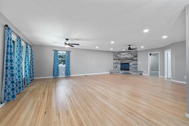 615 18th Ave, Minot, ND 58701 - unfurnished living room featuring a ceiling fan, light wood-style floors, recessed lighting, and a fireplace