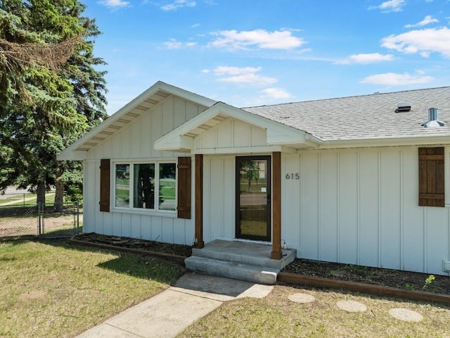 615 18th Ave, Minot, ND 58701 - property entrance with a shingled roof and board and batten siding