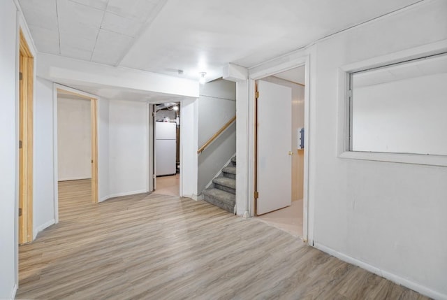 615 18th Ave, Minot, ND 58701 - finished basement with freestanding refrigerator, wood finished floors, and stairs