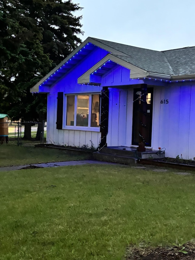 615 18th Ave, Minot, ND 58701 - view of front of house with roof with shingles and board and batten siding