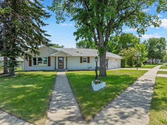 615 18th Ave, Minot, ND 58701 - view of front of property featuring board and batten siding, a front lawn, a garage, and a shingled roof