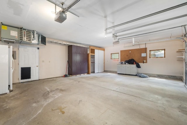 615 18th Ave, Minot, ND 58701 - garage with a garage door opener and freestanding refrigerator