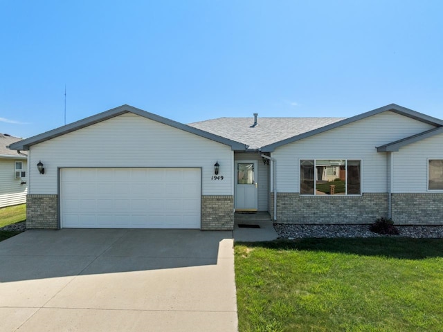 1949 24th St, Minot, ND 58701 - ranch-style house featuring brick siding, a front yard, driveway, and a garage
