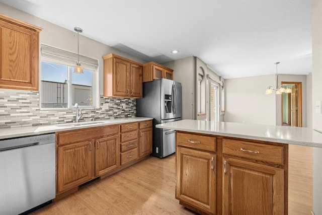 1949 24th St, Minot, ND 58701 - kitchen with appliances with stainless steel finishes, light countertops, backsplash, and recessed lighting